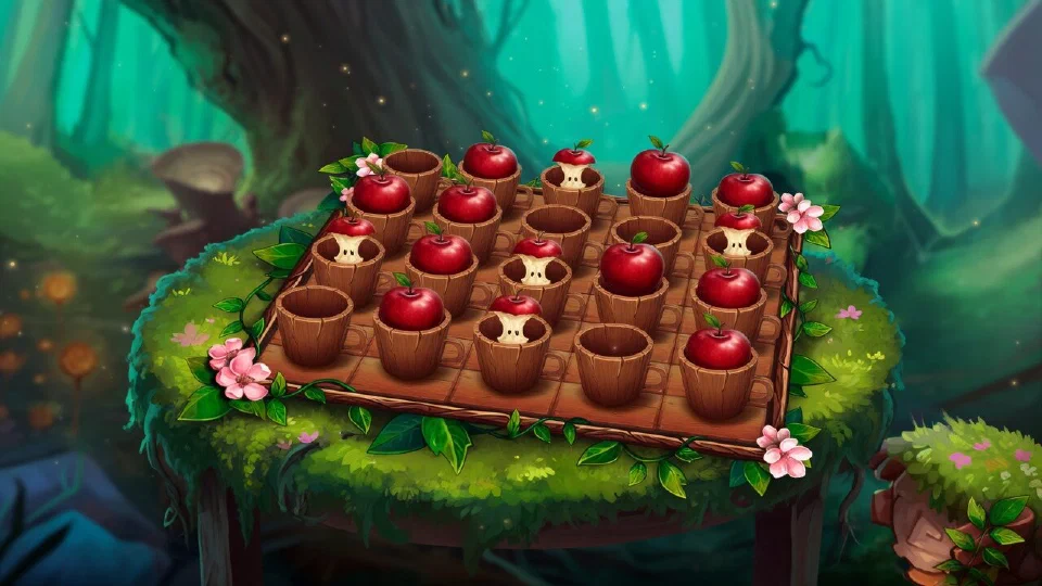 A wooden game board with rows of cups lifted to show whole red apples and a few apple cores on a mossy forest table